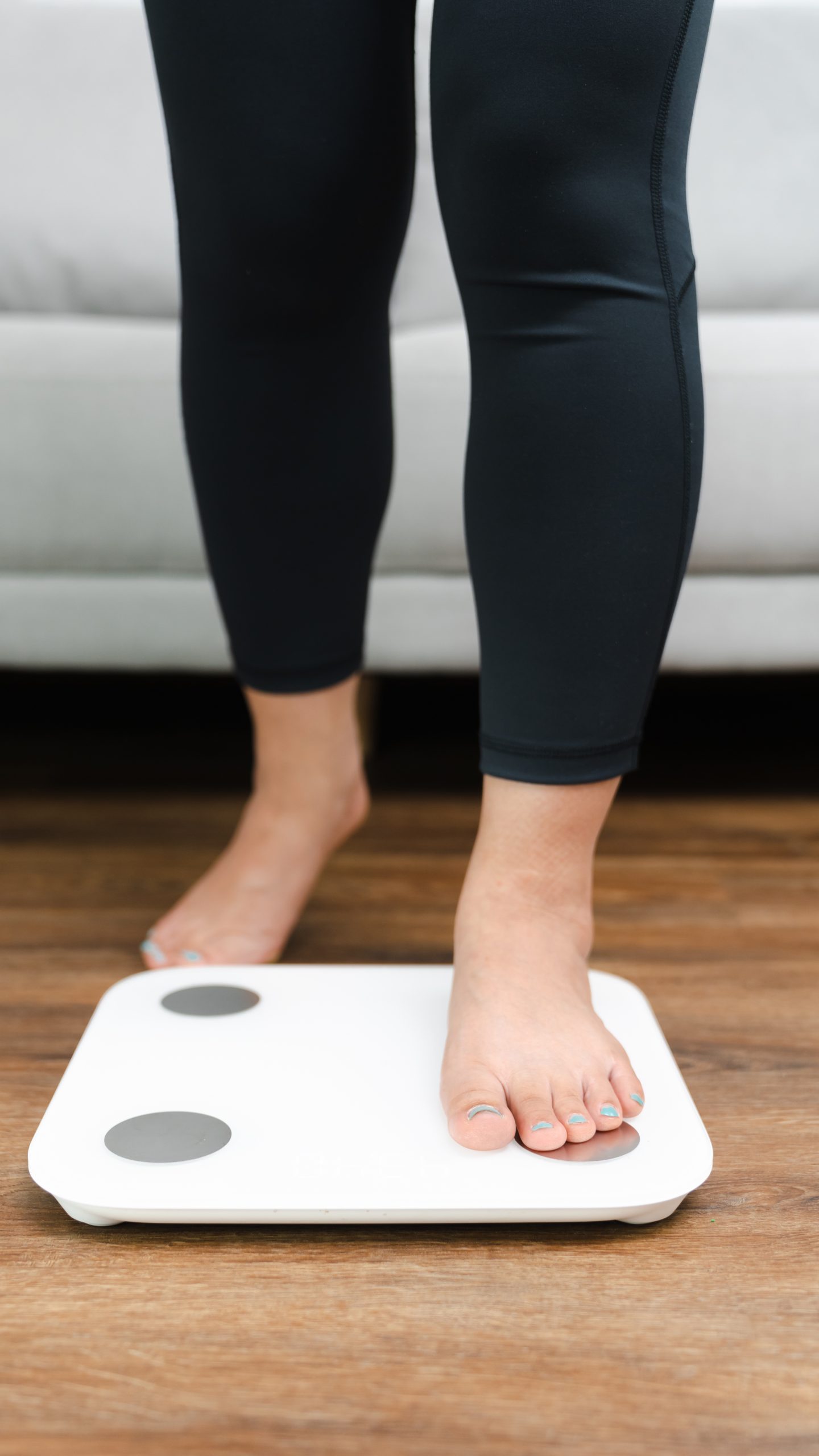 Woman leg stepping on scales at home. Measurement instrument in kilogram for diet Lose weight concept A woman about to step on scale and see if her weight loss service is working